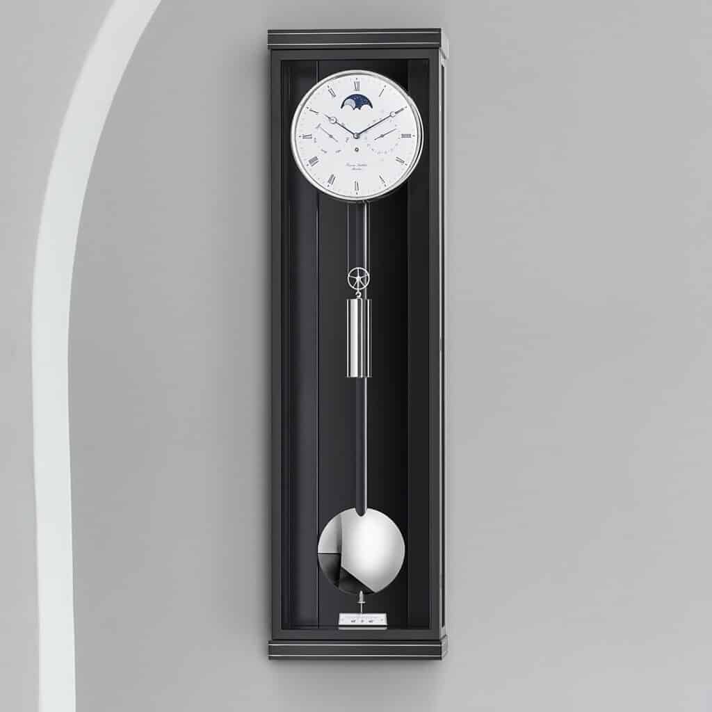 Eine elegante Wanduhr mit Pendel und Mondphasenanzeige, schwarzes Gehäuse, vor grauem Hintergrund, Modell Classica K100M von Erwin Sattler.
